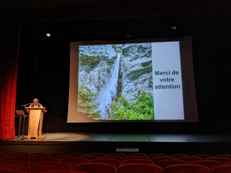 Dernière diapositive de la conférence d'Alain Marnezy : une cascade dans une falaise et le message « Merci de votre attention »